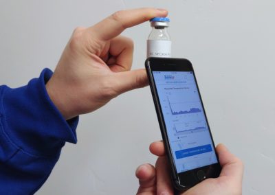 A FleX-NFC tag mounted on a medicine bottle and being scanned by a phone