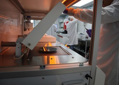 Employees working in our Chip Scale Packaging lab